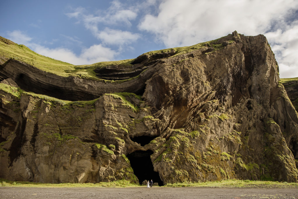 Couple outside of Hjorleifshofdi Cave during their Iceland elopement adventure day