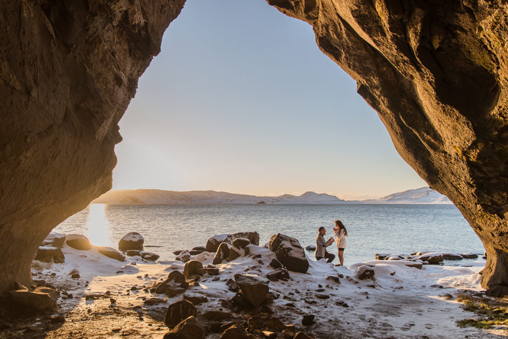 Man proposing in Iceland in a cave on Lake Kleifarvatn