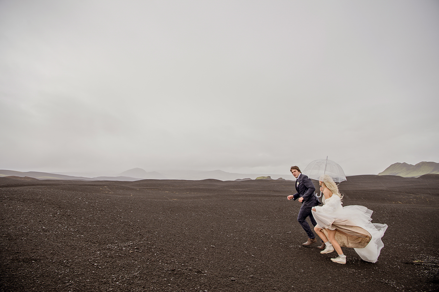 Cameron and Beau running on black desert in Iceland