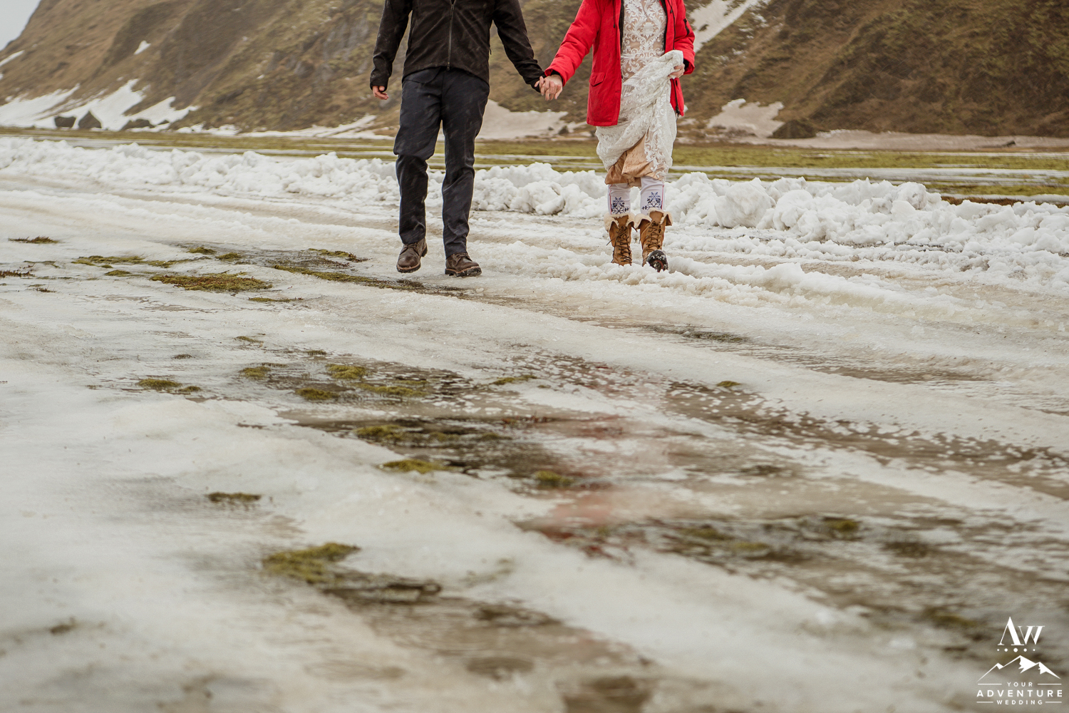Couple walking on snow in Iceland