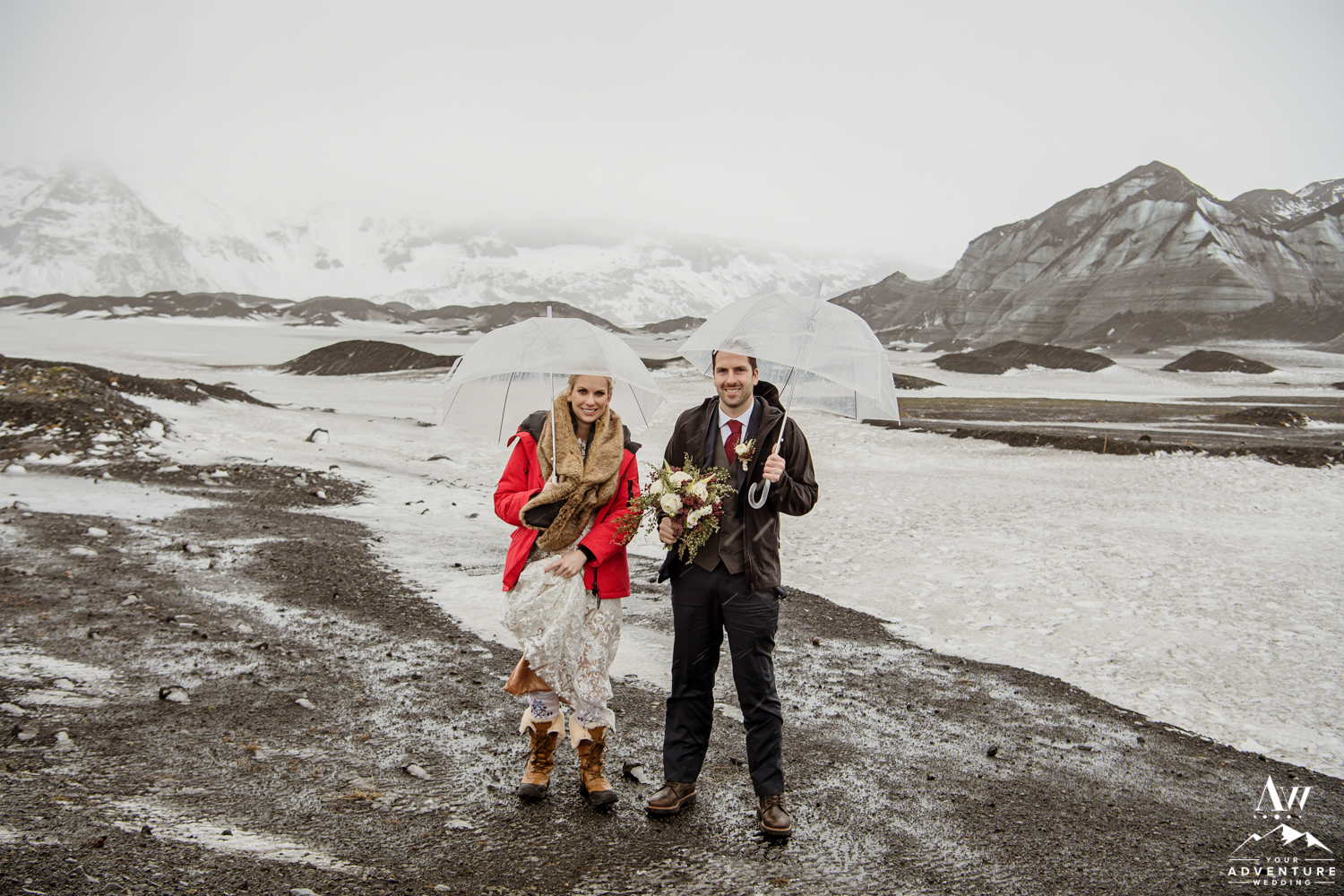 Couple in the rain at a glacier on the wedding day