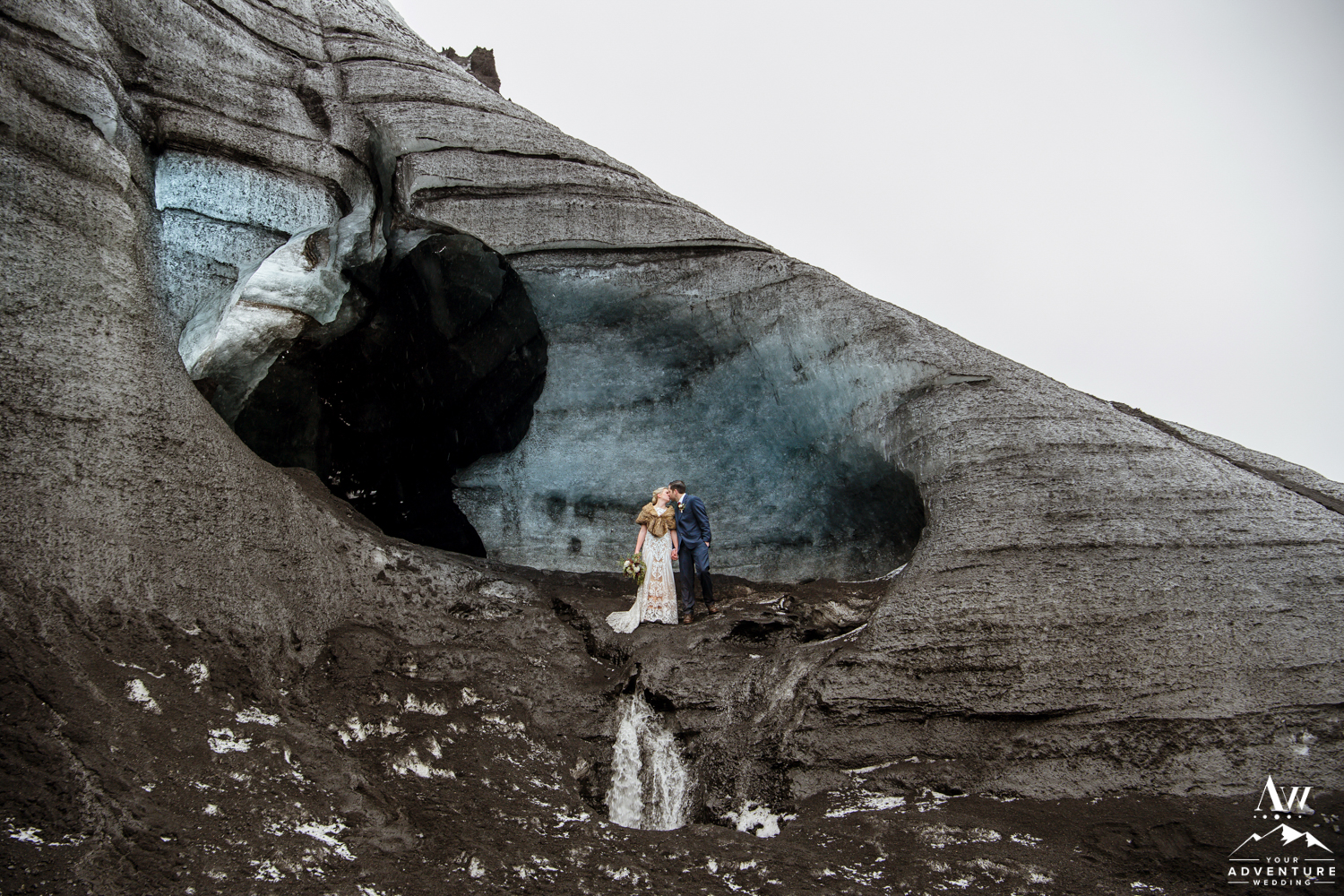 Couple having wedding photos in front of an ice cave