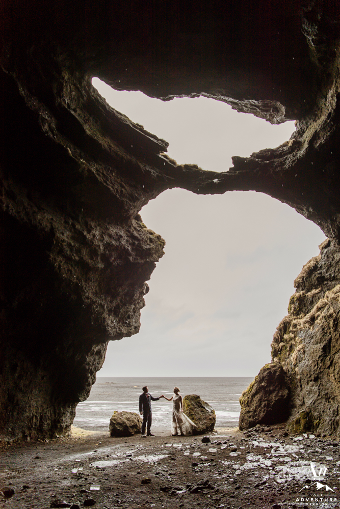 Couple inside of hjorleifshofdi cave for wedding photos
