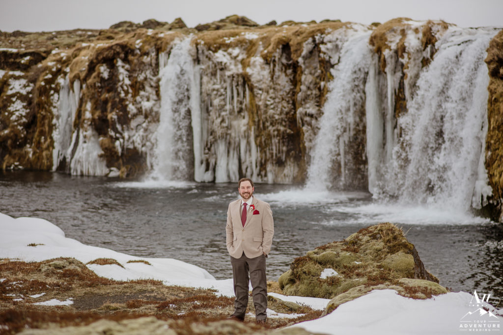 Iceland Groom standing in front of private waterfall