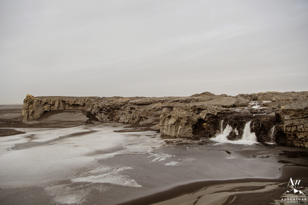Black Sand Beach Lava Rock Waterfall in Iceland