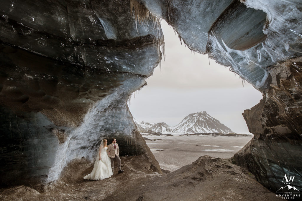 Couple Standing inside of an Ice Cave while Eloping in Southern Iceland
