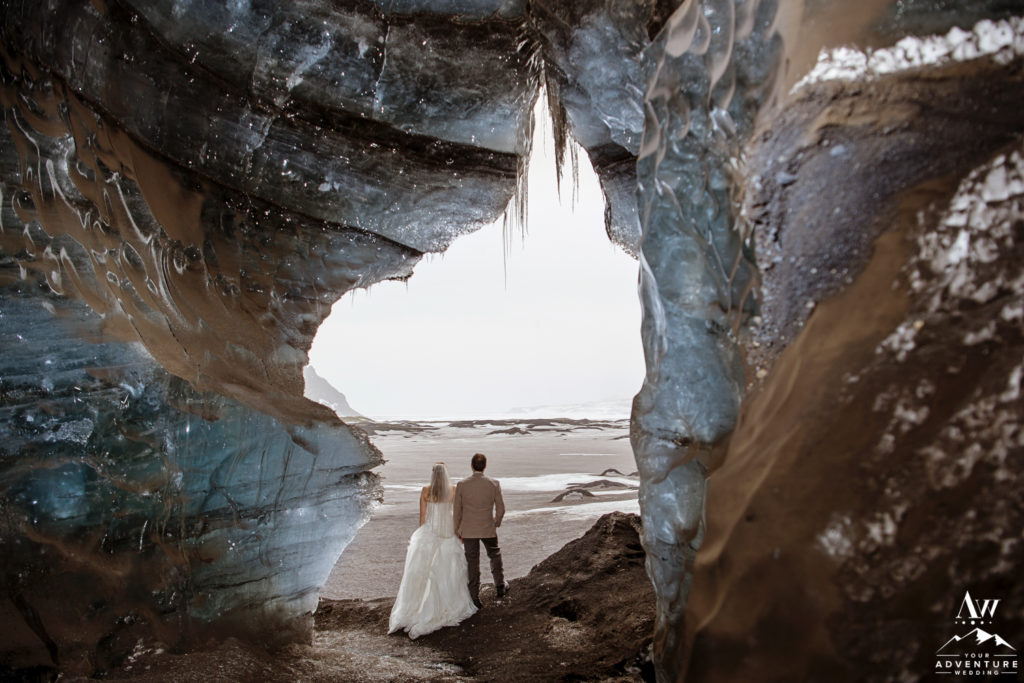 Adventurous Couple exploring an Ice Cave during Elopement