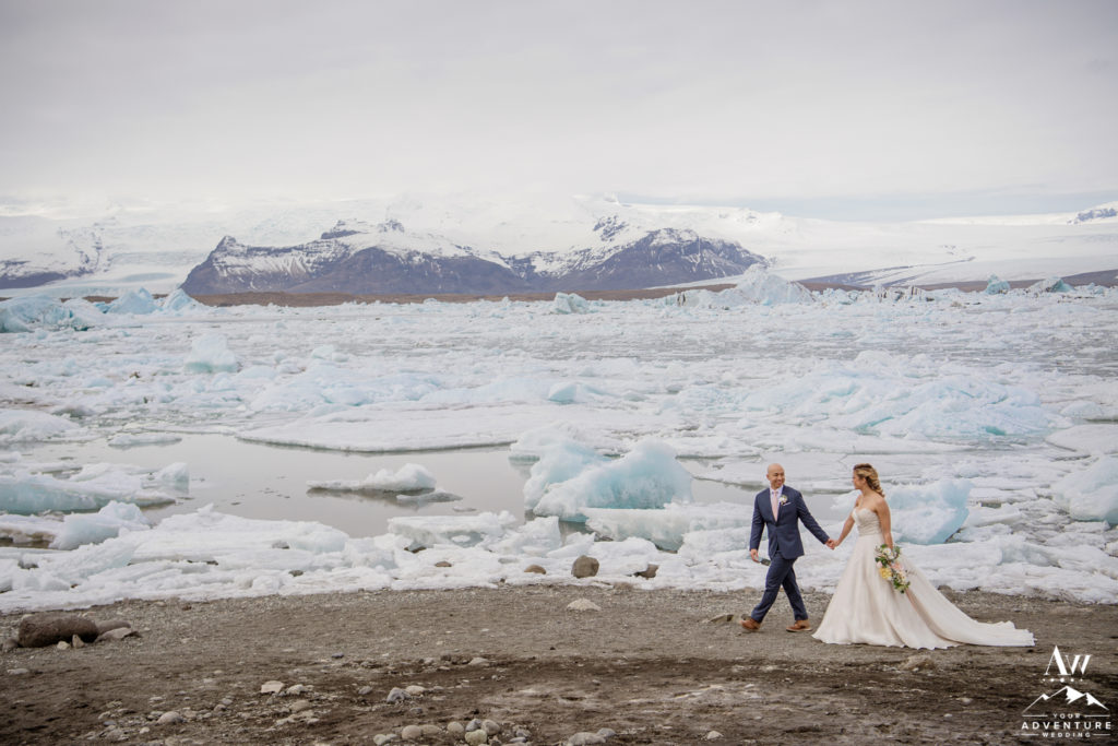 Iceland wedding couple walking at glacier lagoon