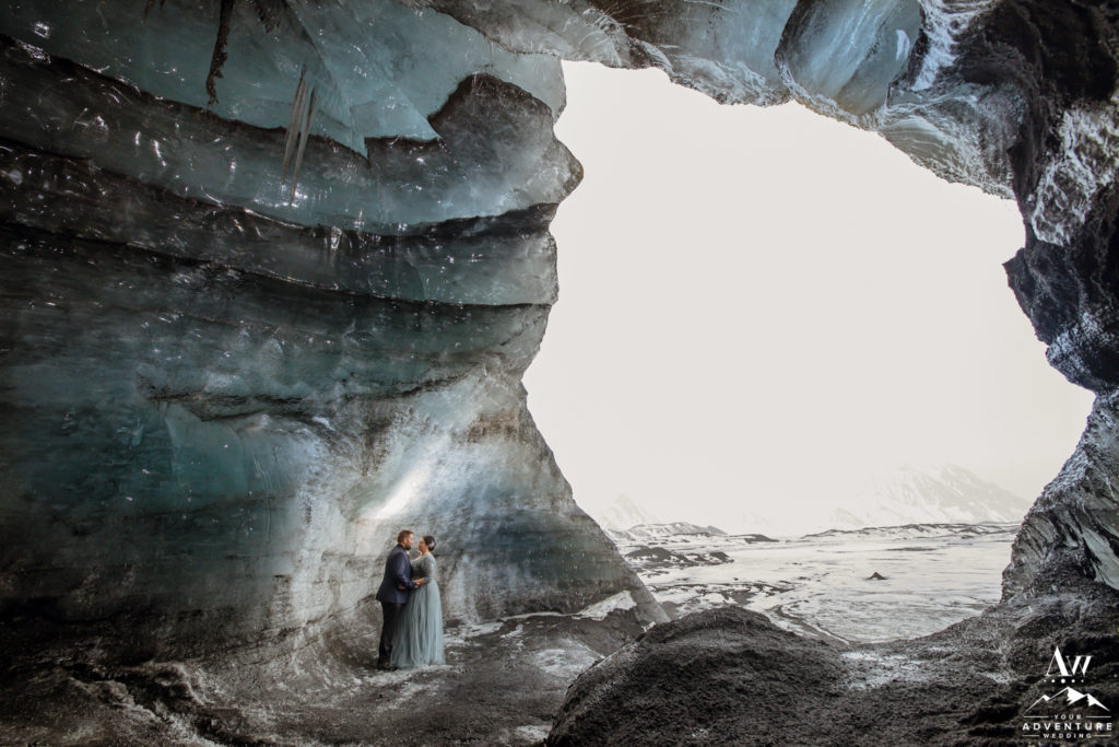 Iceland Wedding Couple standing inside of an ice cave