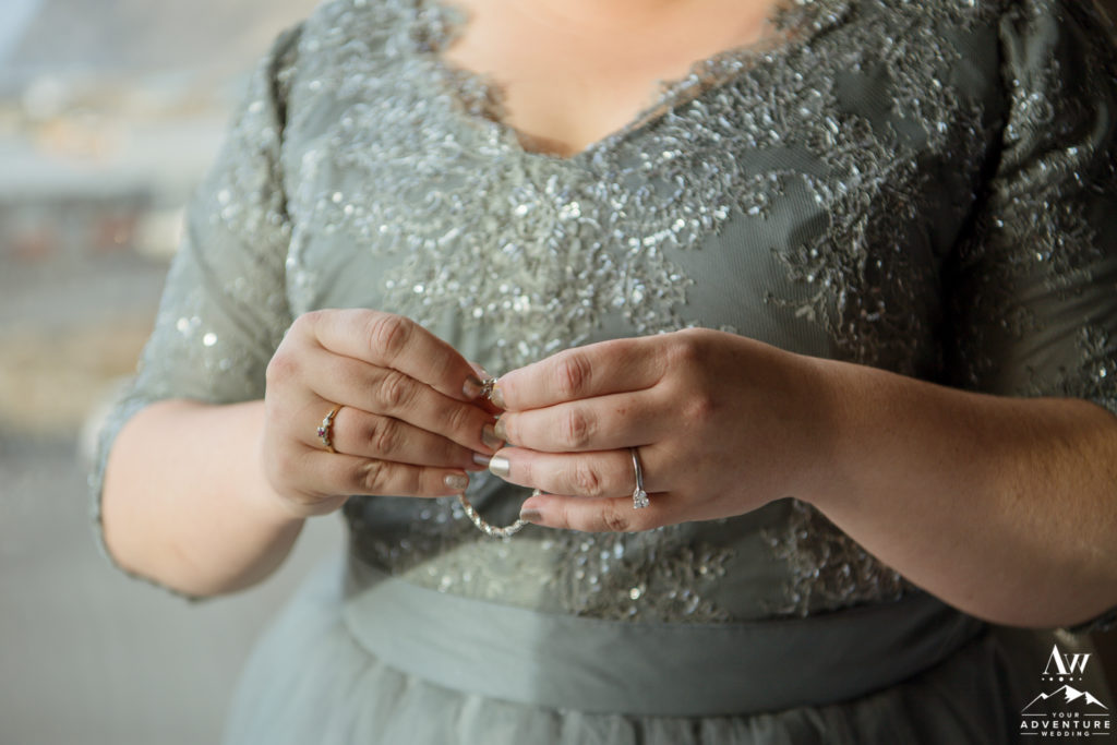 Iceland wedding bride putting on her jewelry