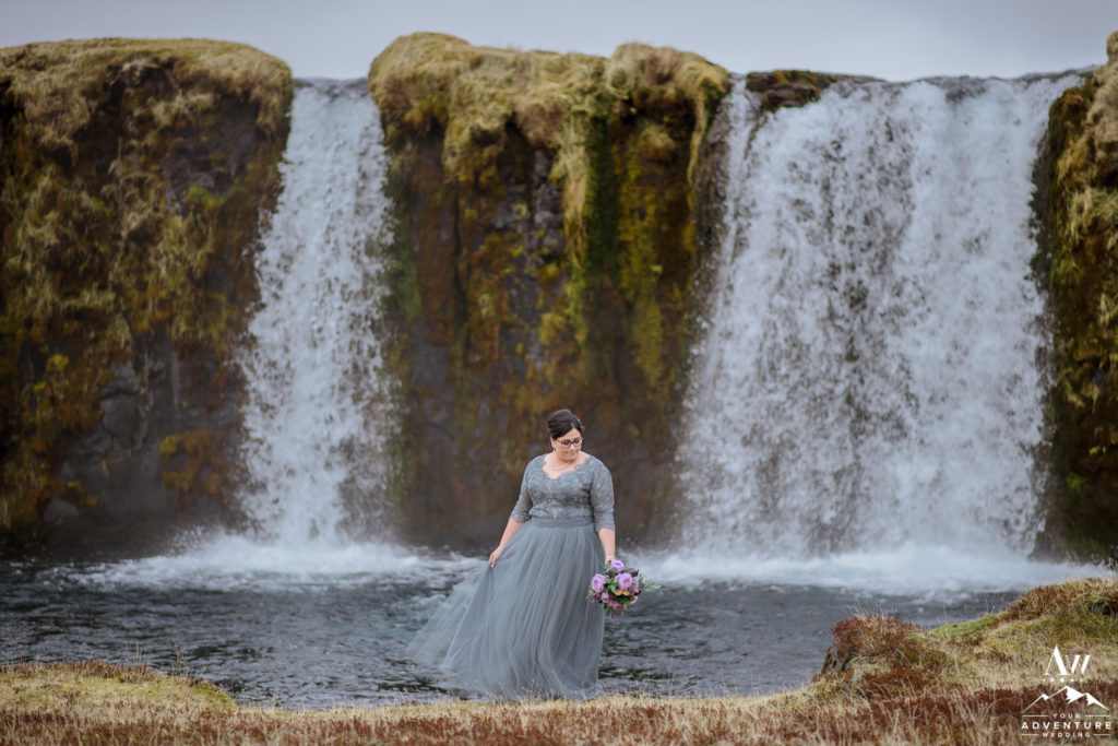 Bride in front of a private waterfall in Iceland