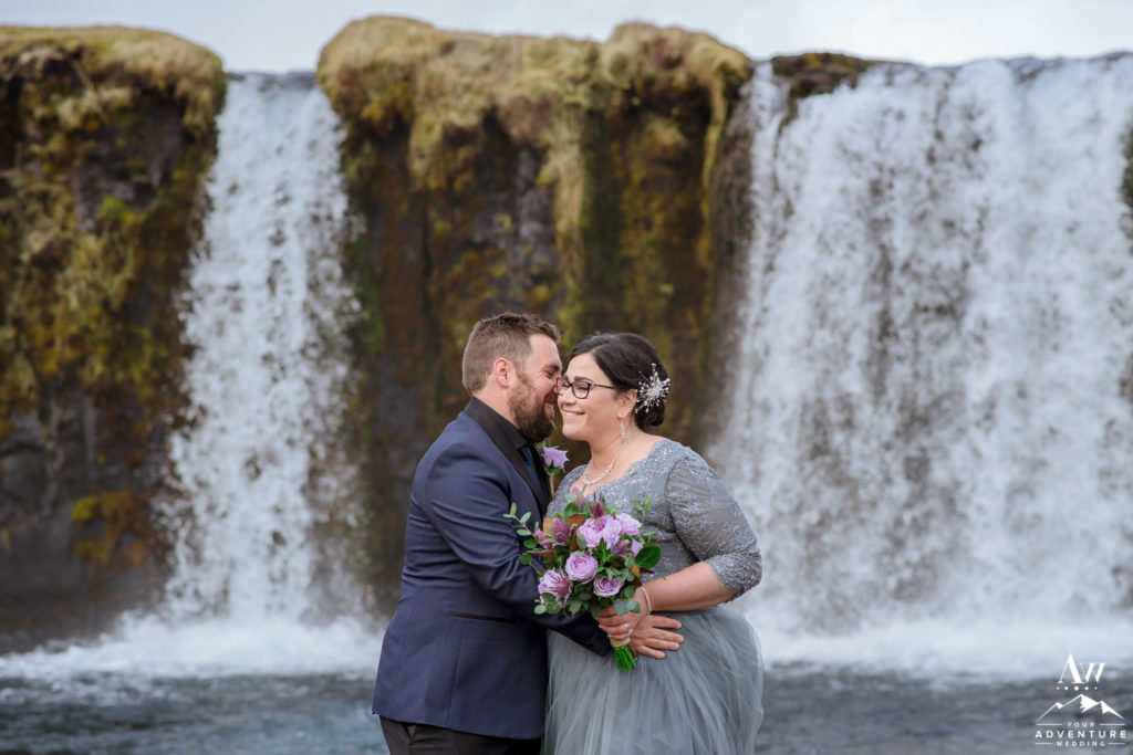 Iceland Wedding couple kissing in front of a private waterfall