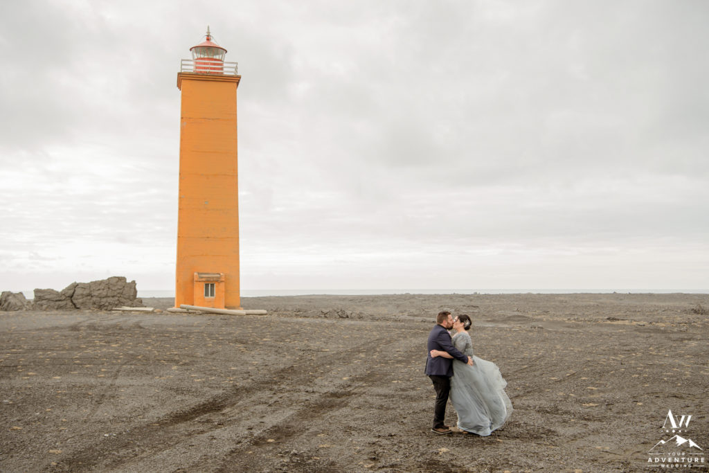 Iceland Wedding Couple Kissing in front of a orange lighthouse