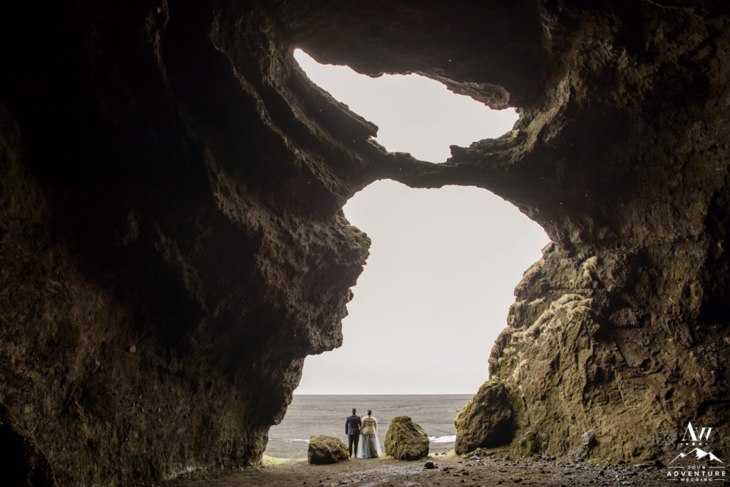 Iceland Wedding Couple Standing at the opening of hjorleifshofdi cave