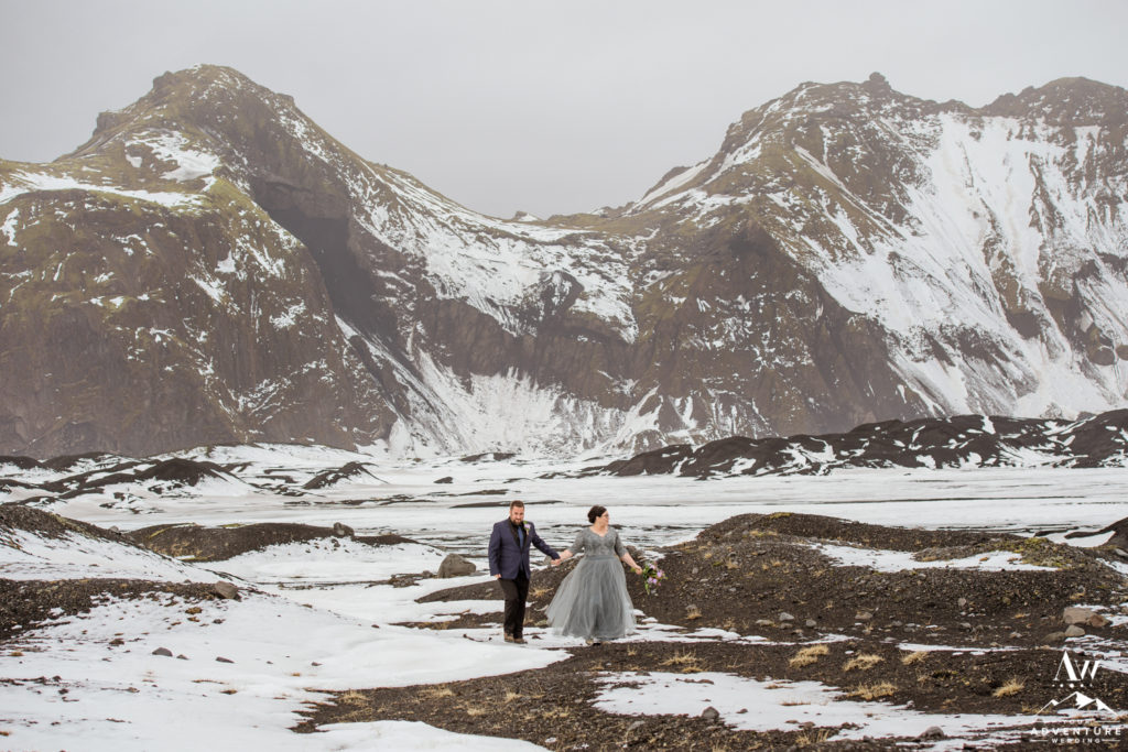 Couple in front of a snowy mountain during April wedding in Iceland