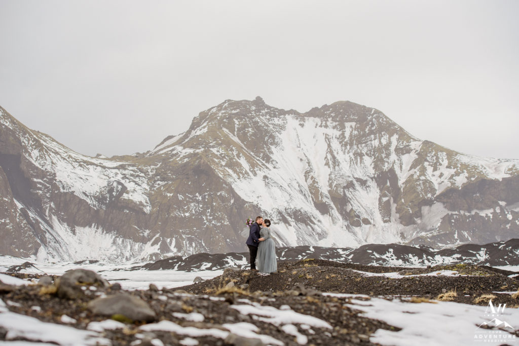 Blue Dress Bride kissing at an Icelandic Glacier Area