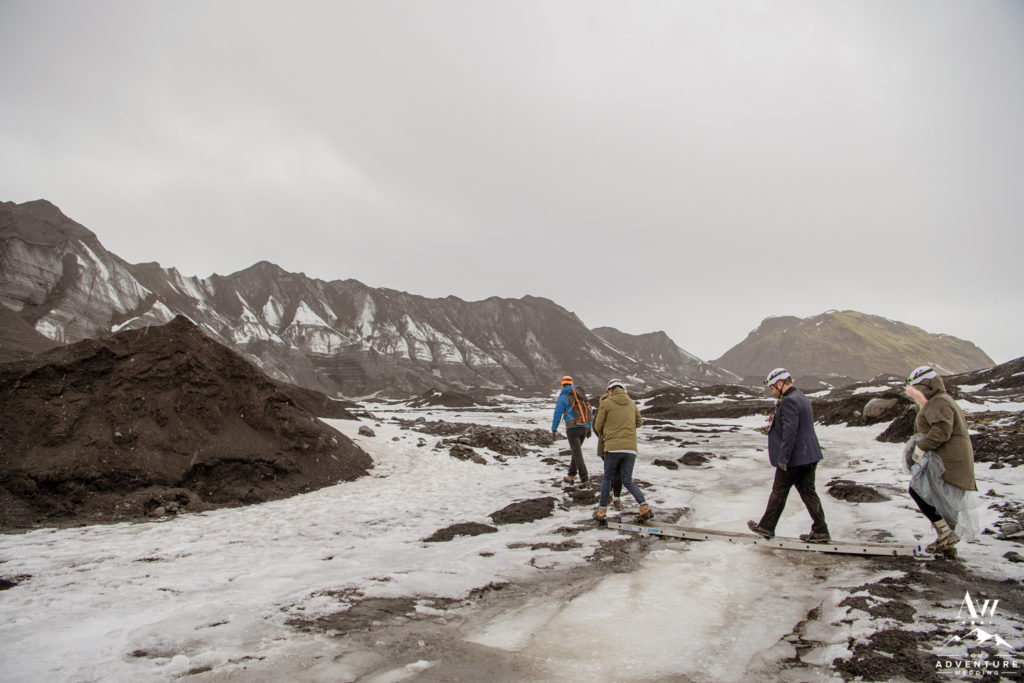 Couple crossing a bridge to a glacier during Iceland Wedding