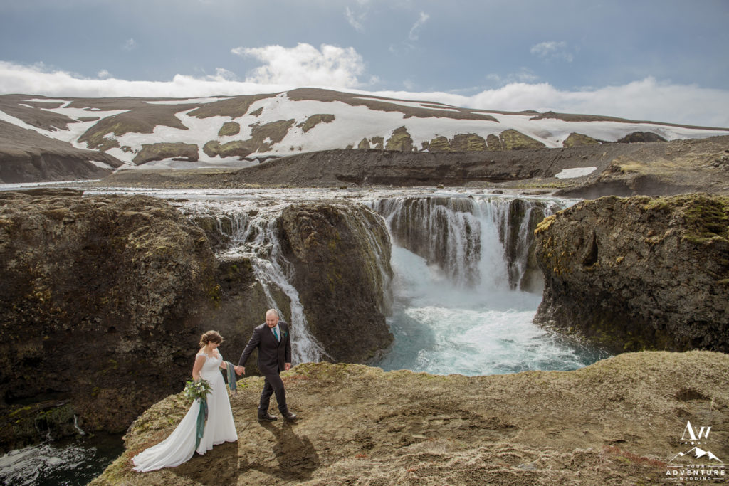 Iceland Wedding Couple Walking in front of a waterfall