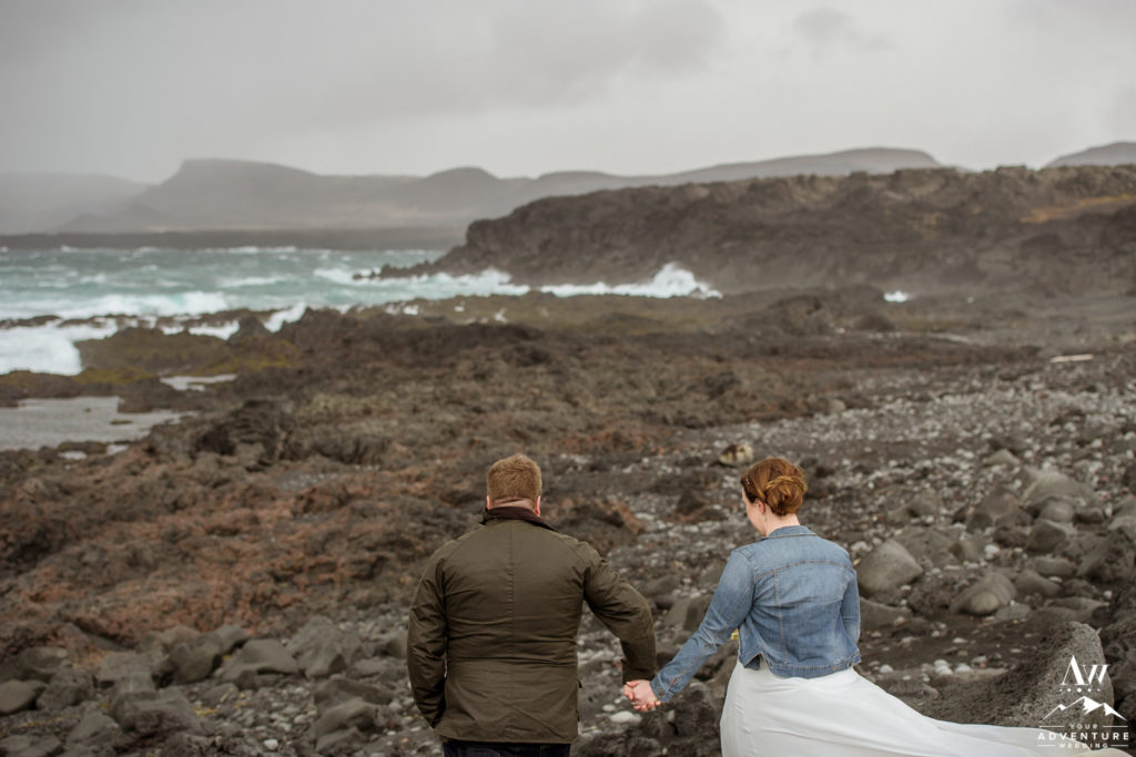 Iceland Elopement Couple exploring a black lava rock beach