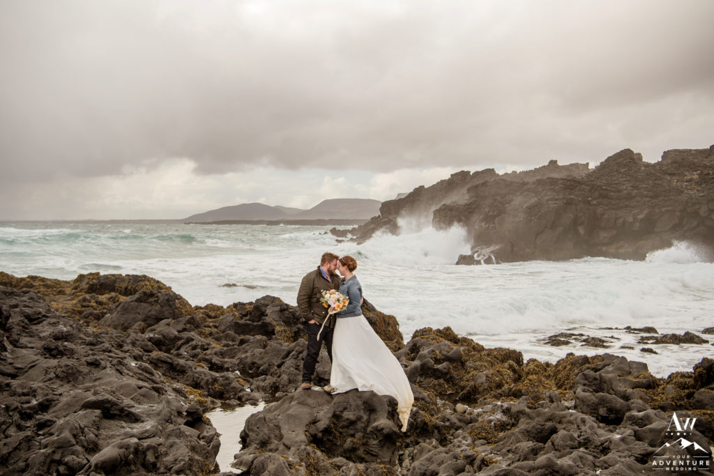 Iceland Wedding Couple with giant waves behind them