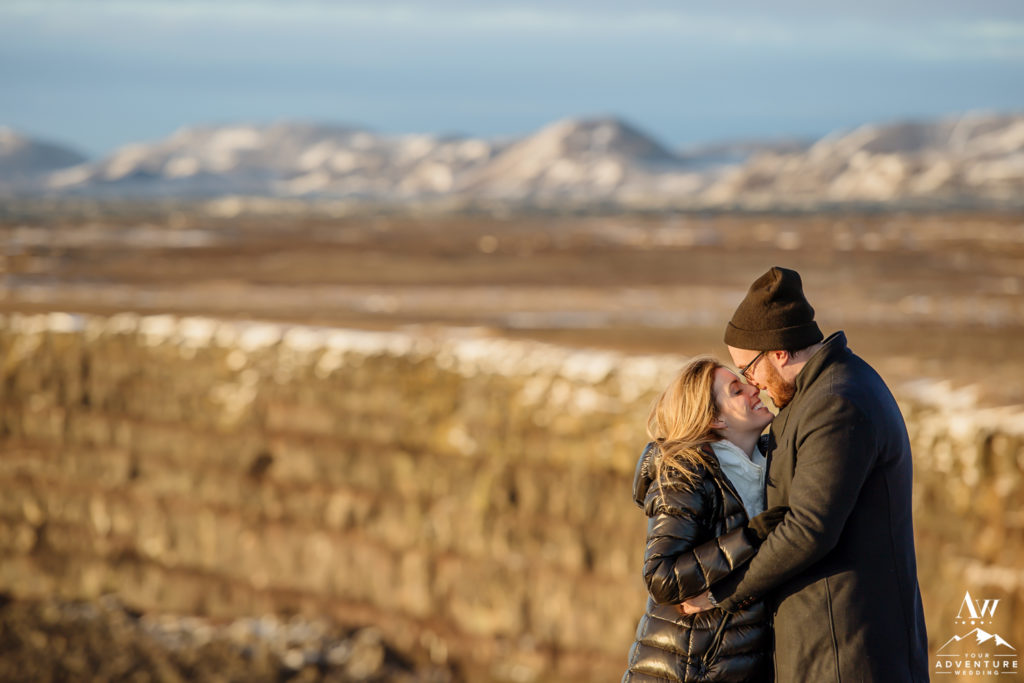 Couple kissing on top of golden cliffs in Iceland