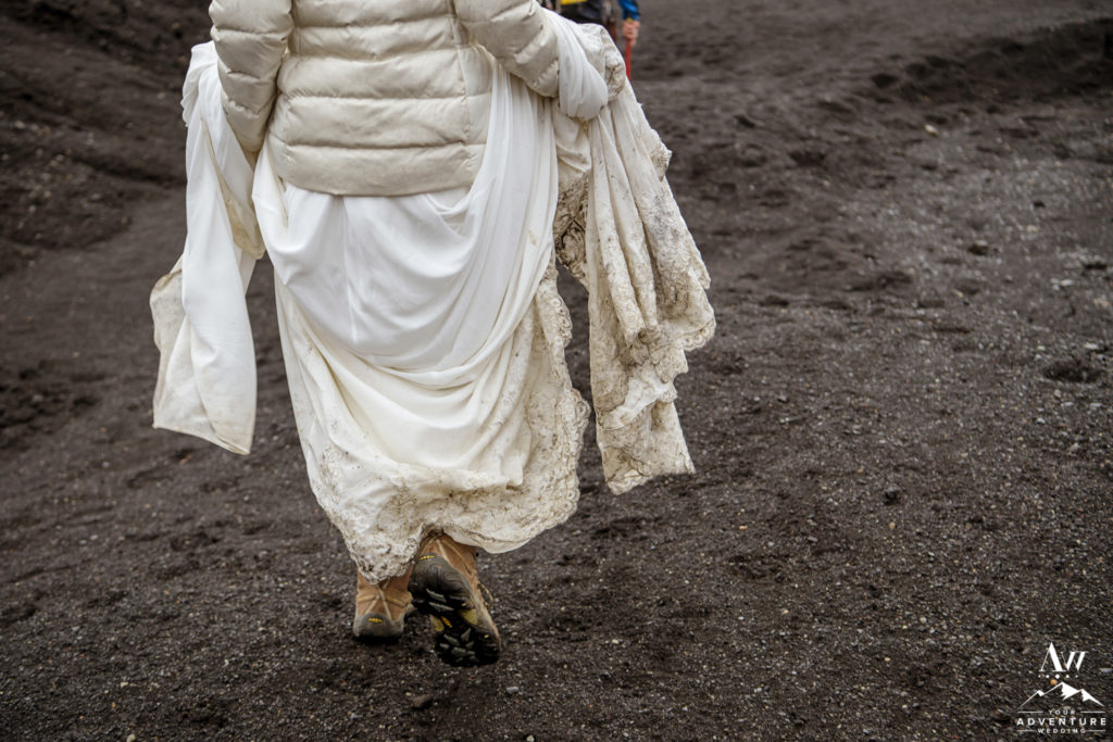 Bride Carrying her dirty dress from the adventure