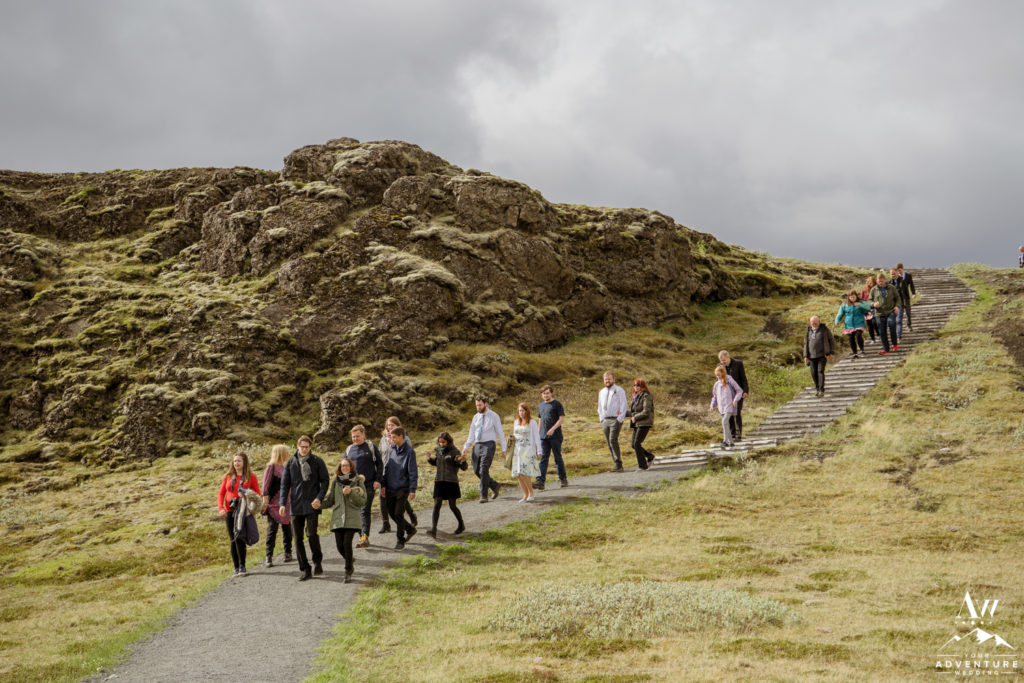 Guests walking down to Hjalparfoss Waterfall