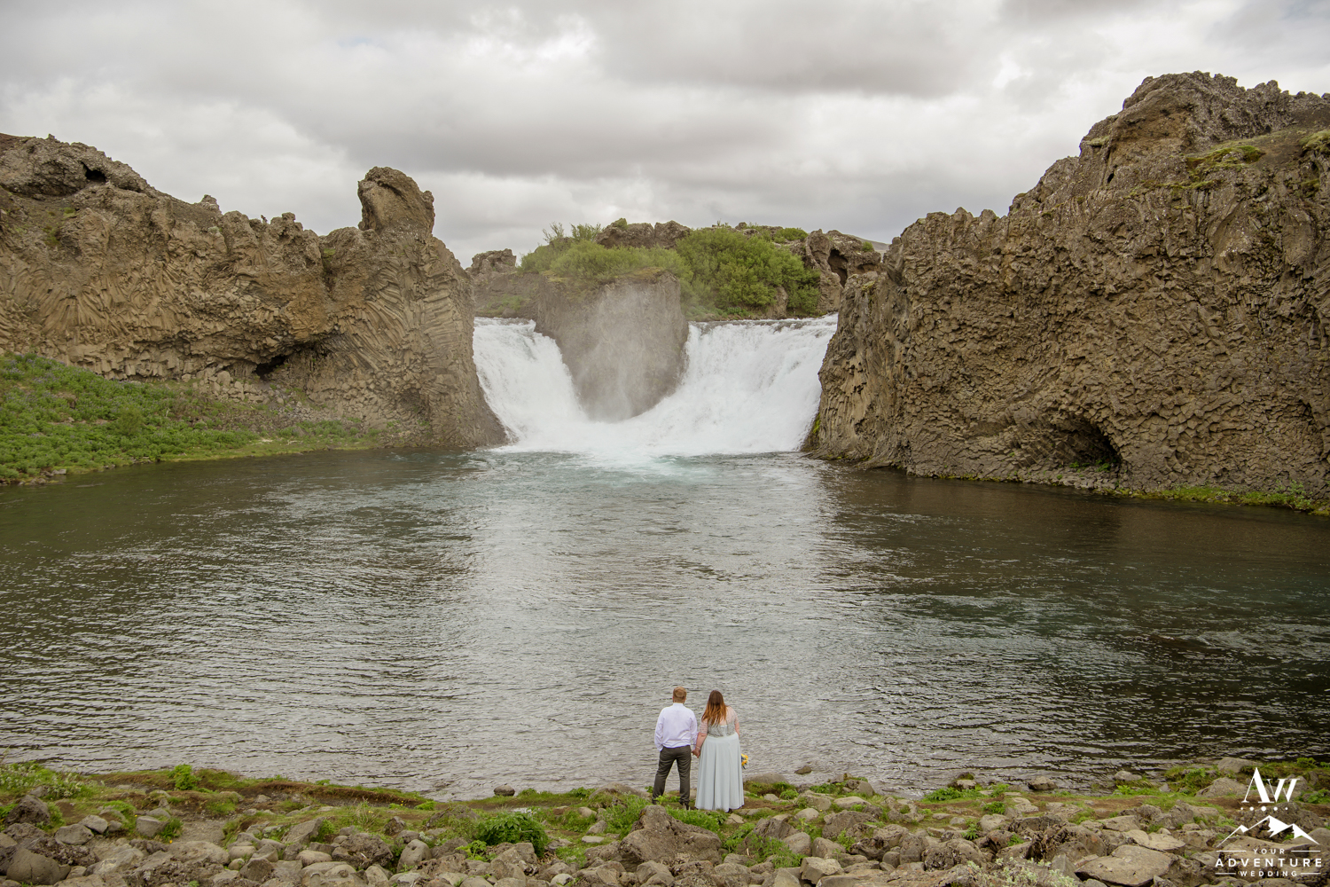 Hjalparfoss Waterfall Wedding Couple looking at the Falls