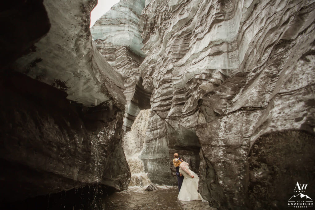 Iceland Wedding Couple Exploring an ice cave waterfall