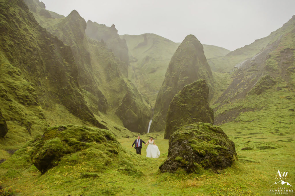 Couple running through a Icelandic Canyon