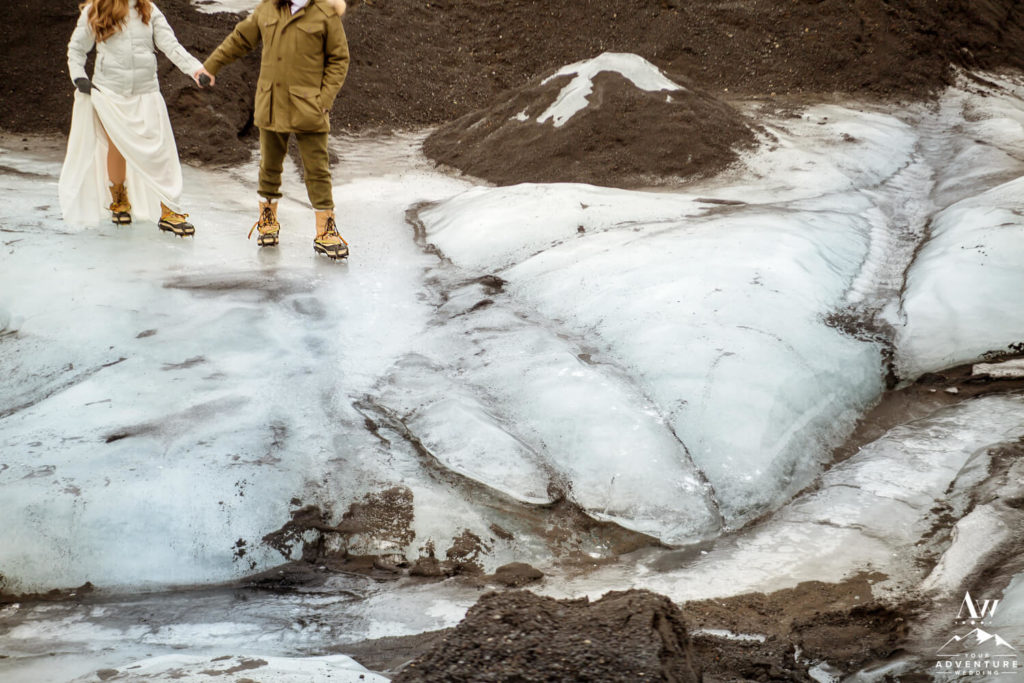 Iceland wedding couple hiking in ice climbing crampons