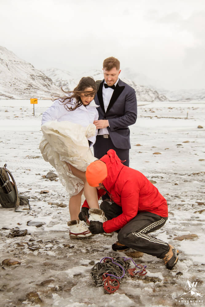 Iceland elopement couple putting on crampons