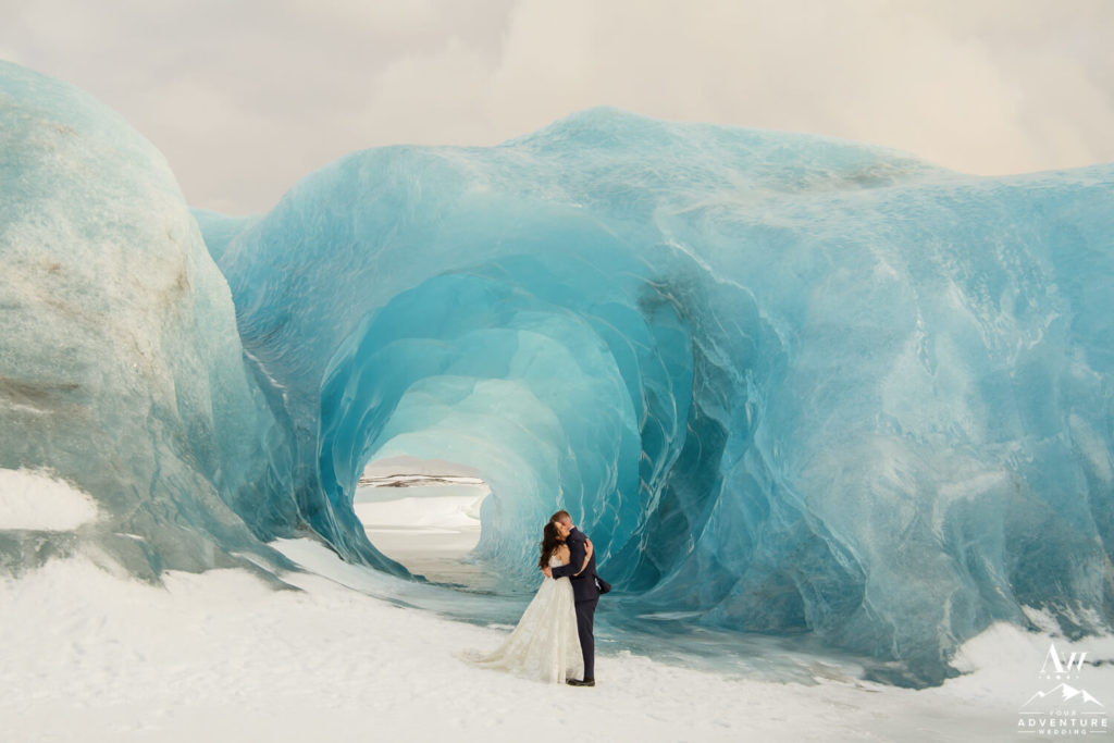 Iceland Elopement Couple Hugging in front of Blue Ice Cave