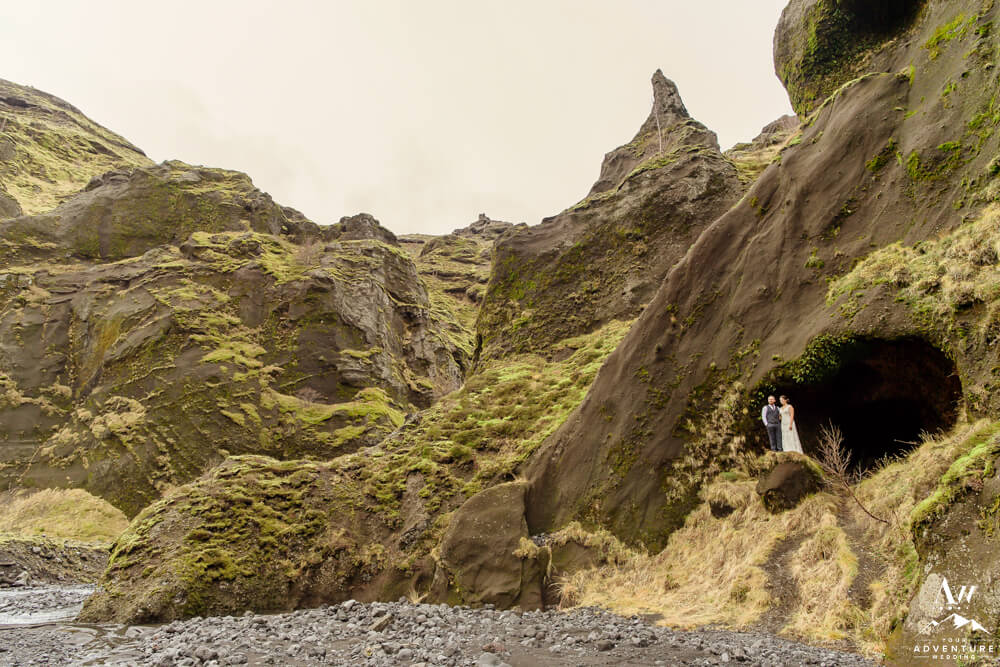 Iceland wedding couple standing in cave at Stakkholtsgjá