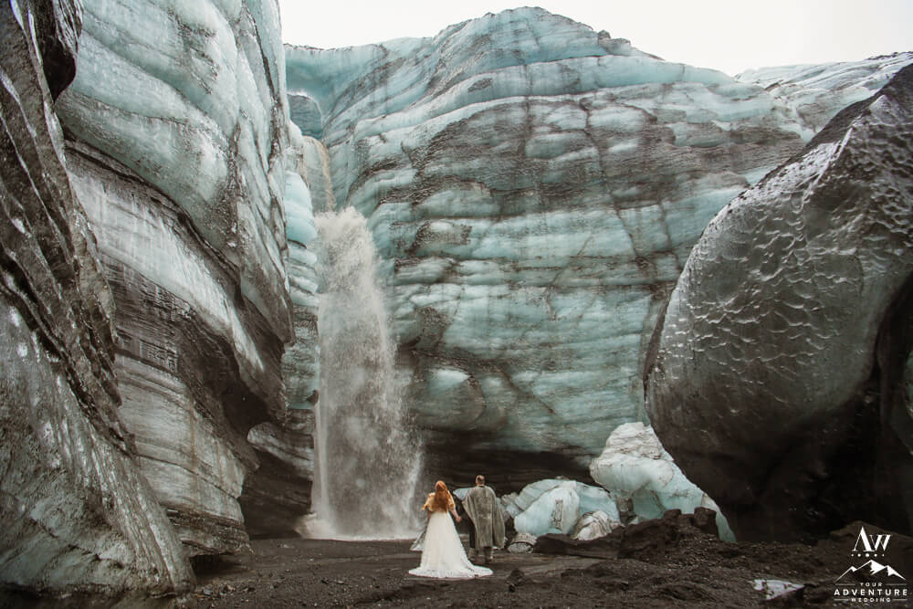 Viking Themed Wedding Couple in front of glacier waterfall