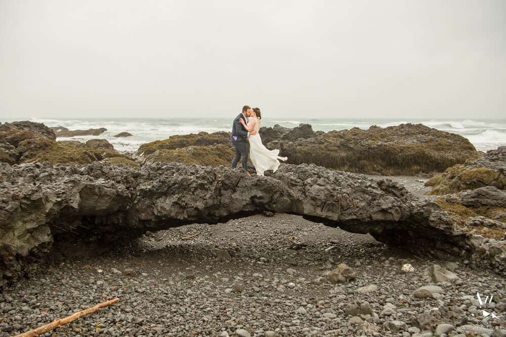 Iceland Wedding Couple standing on basalt arch
