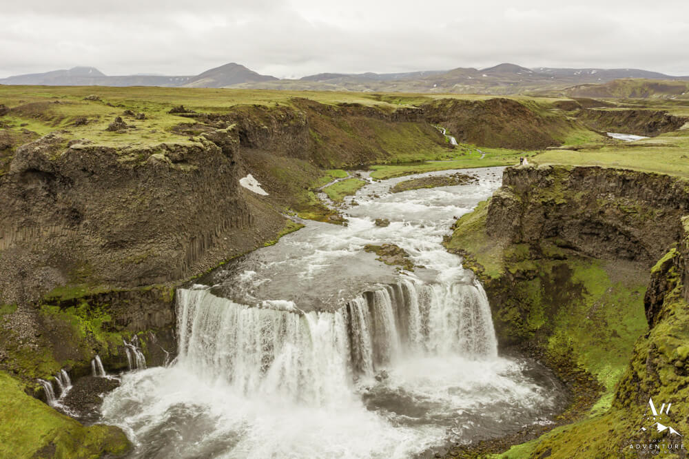 Iceland July Wedding Couple on top of waterfall