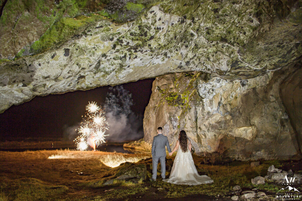 December Elopement Couple in Icelandic Cave with Fireworks